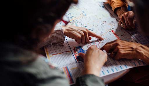 person pointing to a location on a map