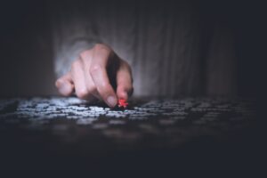 Person putting together a jigsaw puzzle
