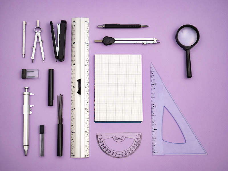 Various measuring tools on purple background.