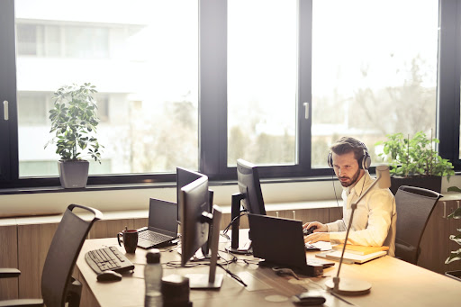 man with headphones on at a desk working