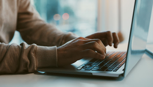 hands typing on a keyboard