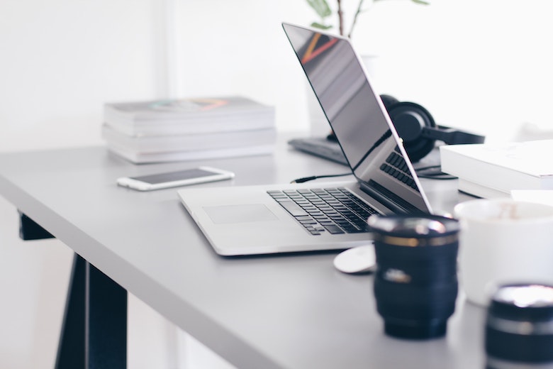 White laptop on a white table