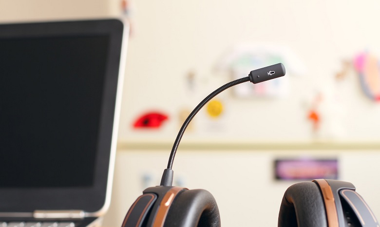 close up image of a headset mic next to a laptop